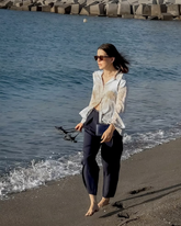 a lady wears a map printed shirt with navy blue loose fit pants